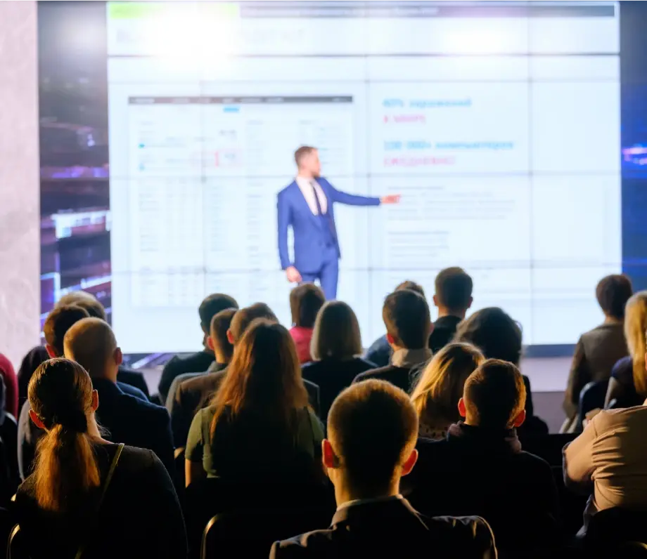 Looking from audience at man giving presentation