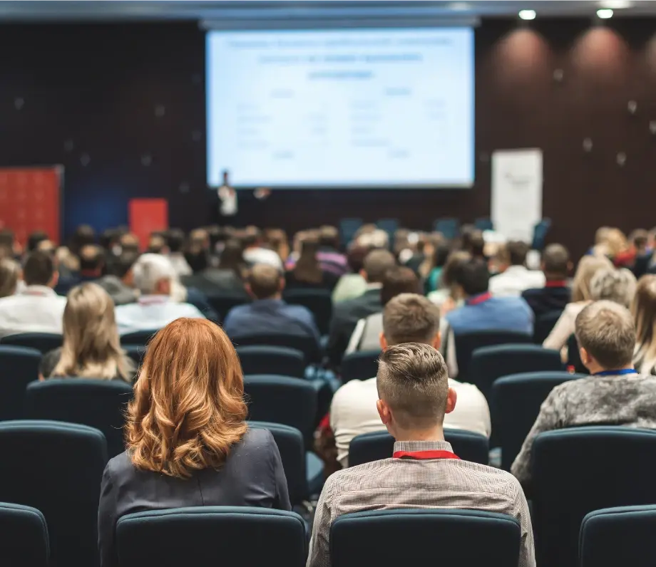 Rows of people watching a presentation