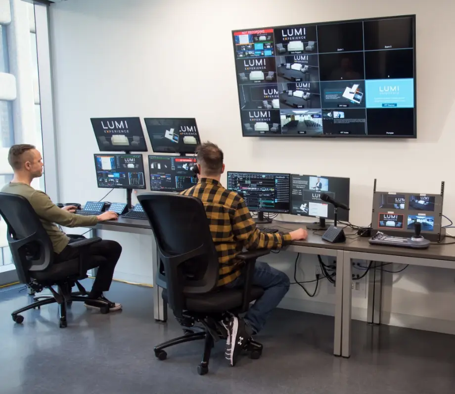 Two men working at multiple monitors